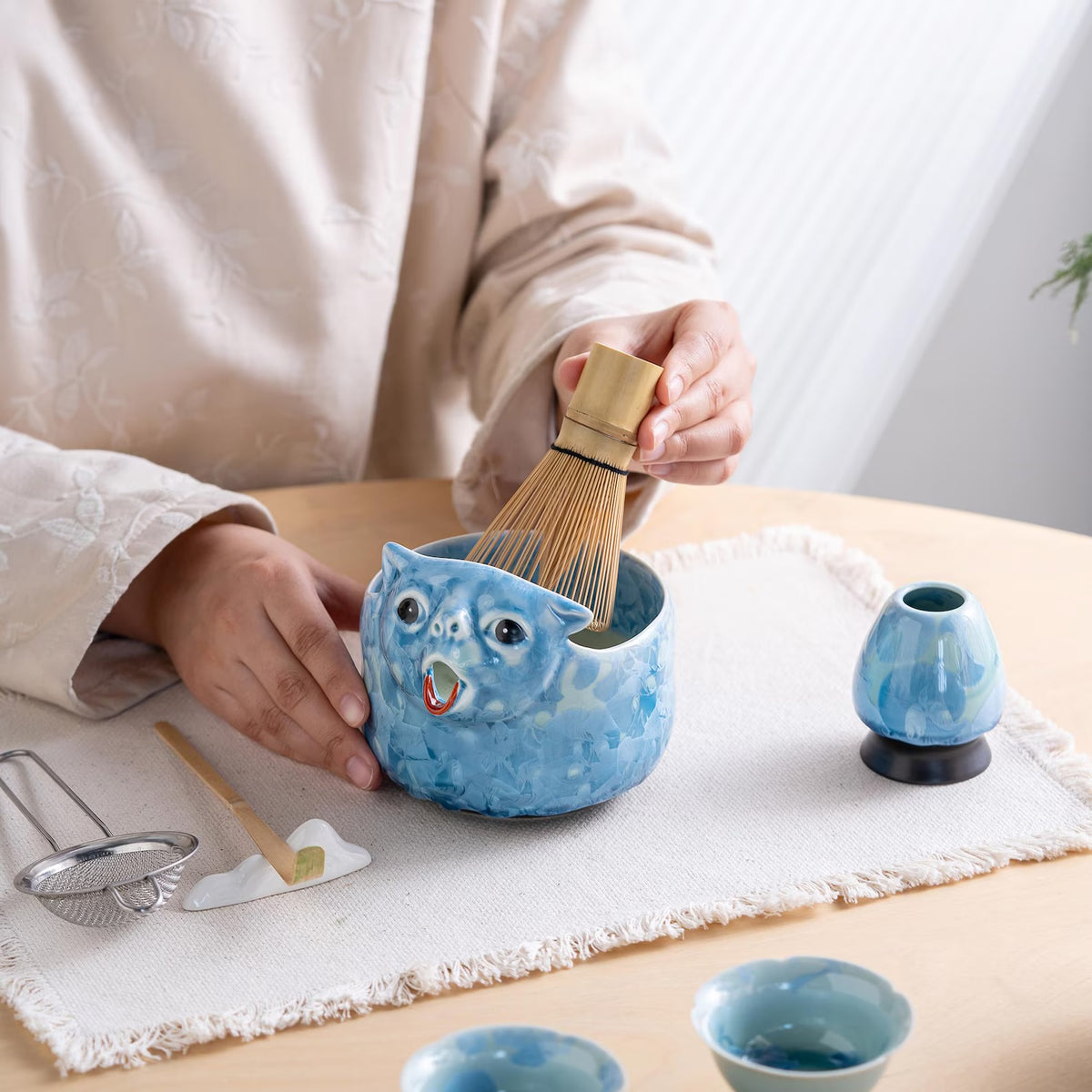 Whisking matcha in the Glacier Blue cat bowl
